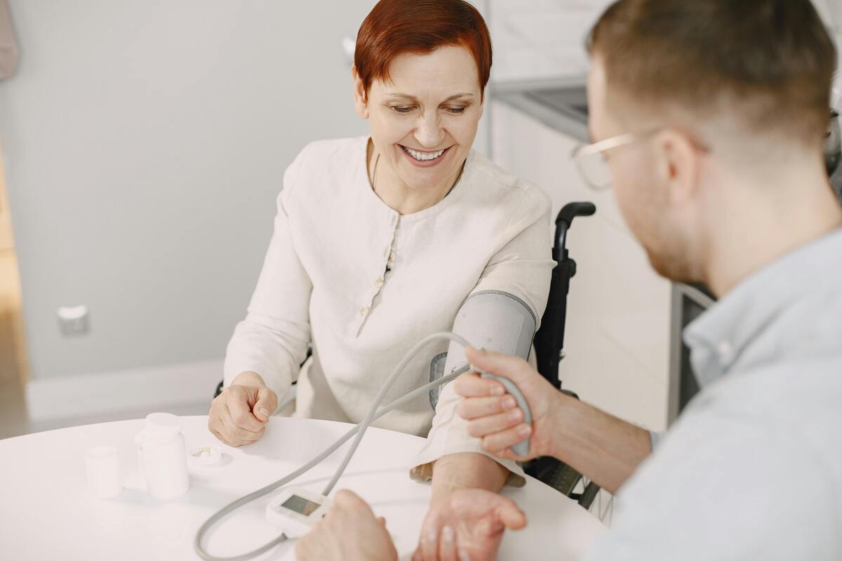 Caregiver helping an older adult in a comfortable home setting